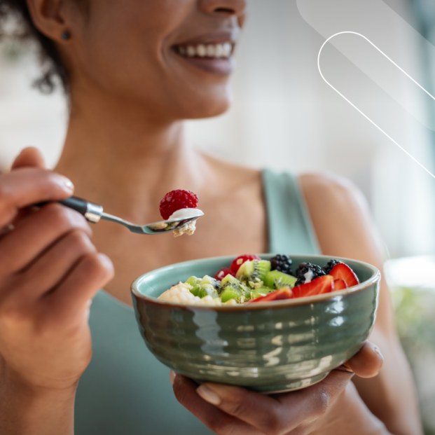 Imagen de una mujer comiendo un boll con cereales y frutas